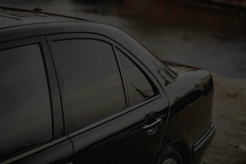 Close-up of a black car with dark tinted windows