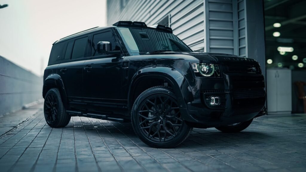 Black SUV with tinted windows parked on a paved driveway