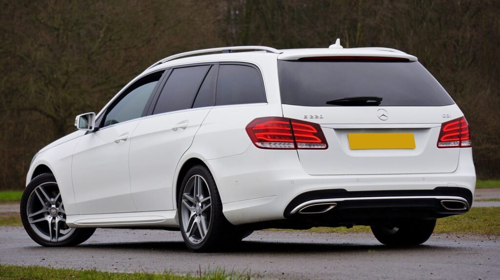 White station wagon with darker tinted rear windows than front windows